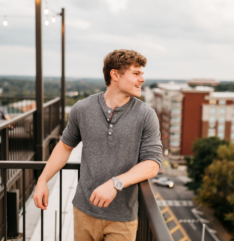 UGA student standing on a balcony in Athens, Georgia.