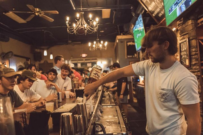 Bartender pouring a drink at Double Barrel, a downtown bar in Athens GA