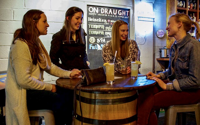 friends enjoying happy hour at The Root in Pine Bar Athens