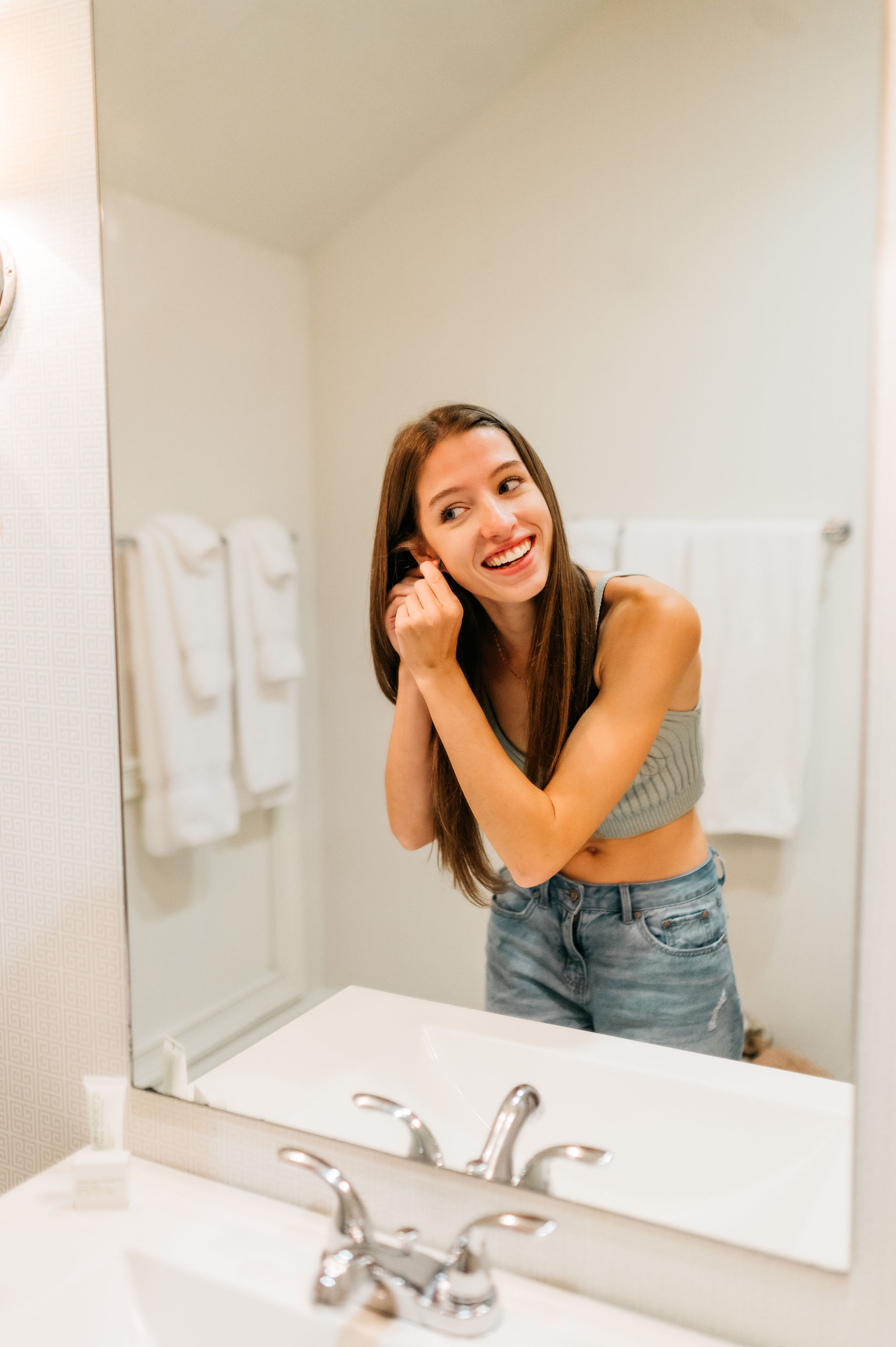 girl getting ready in the mirror 