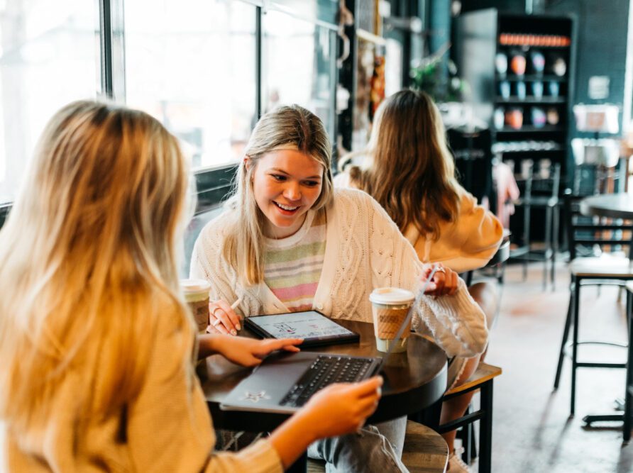 girl looking at a computer in a coffee shop in Athens