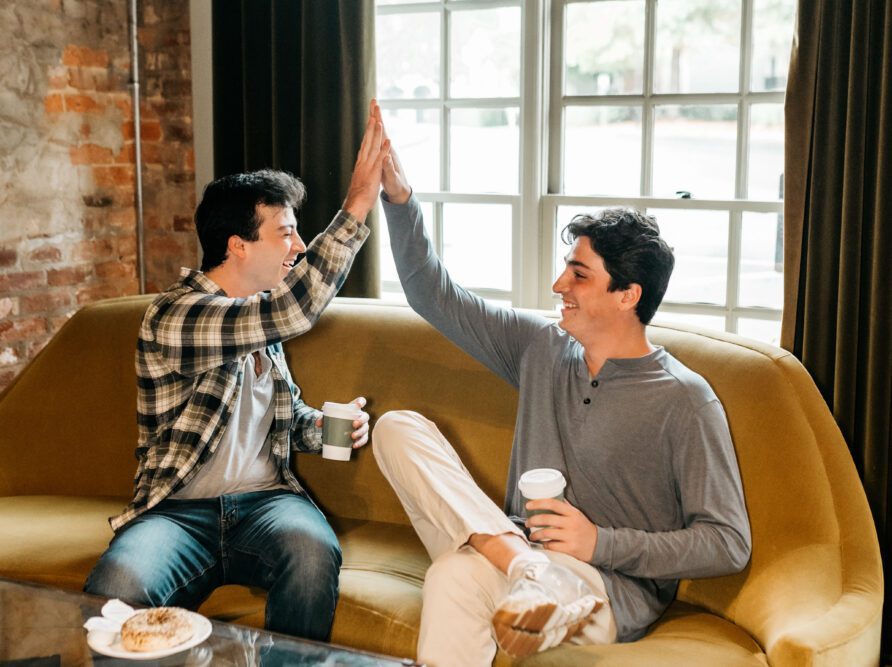 boys high-fiving in coffee shop