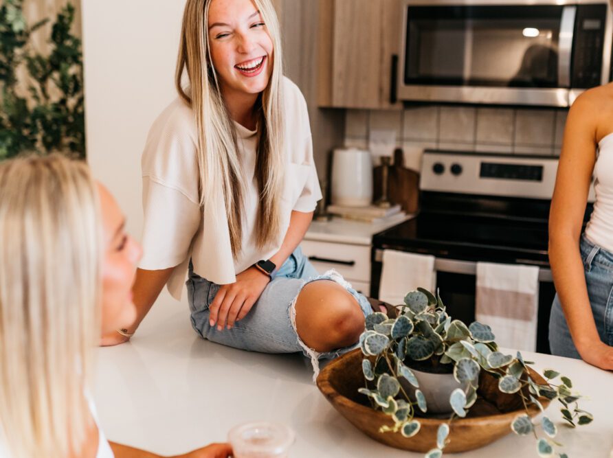 Girl laughing at kitchen island 