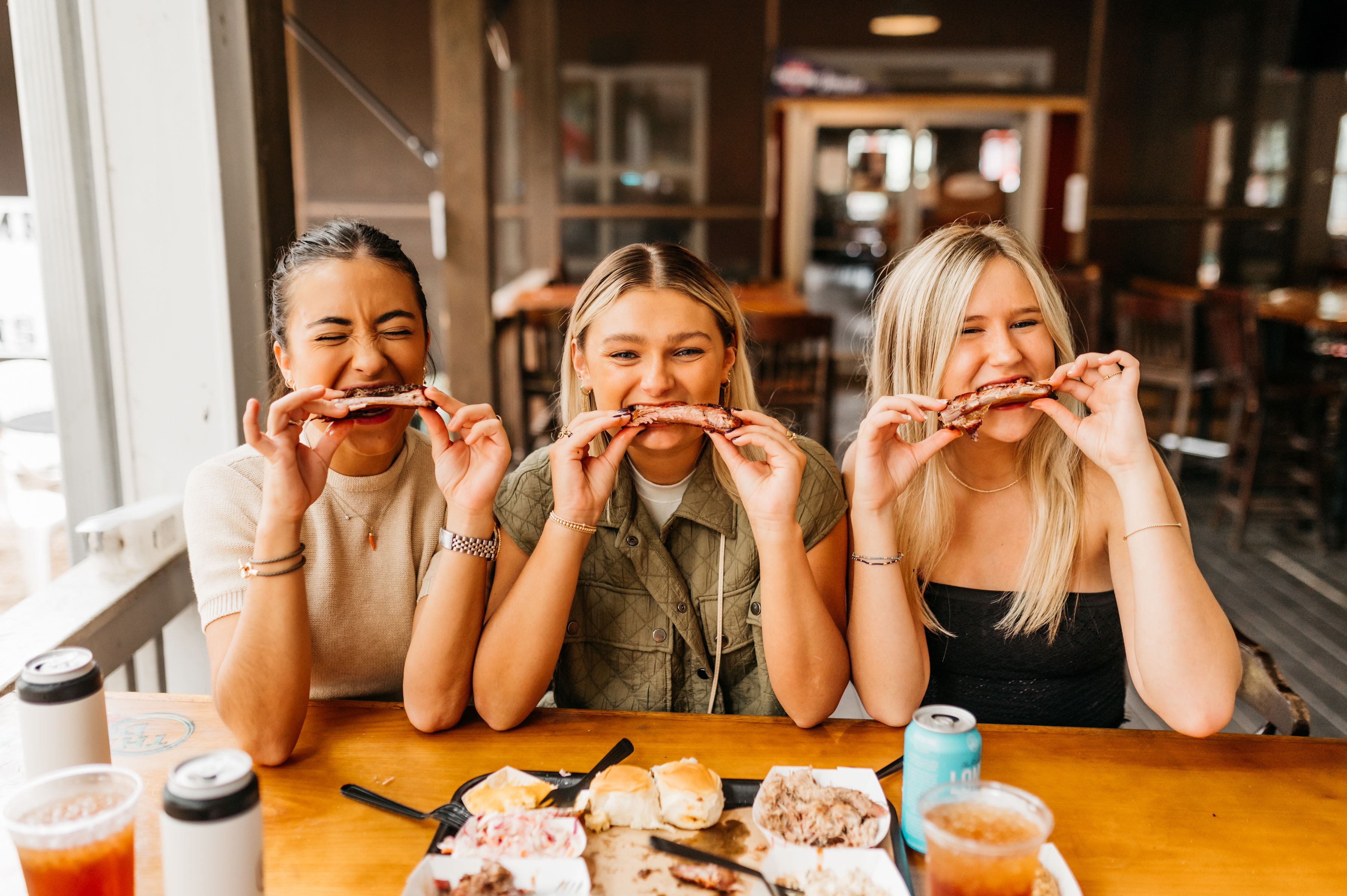 Three girlfriends eating ribs at Saucehouse in Athens, GA