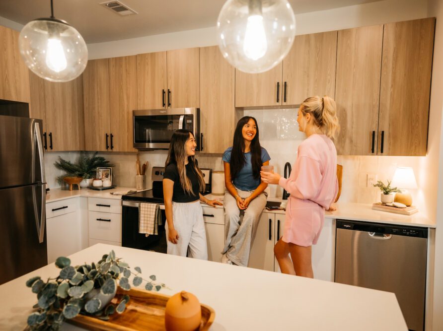 three roommates talking in their kitchen at Rambler Athens