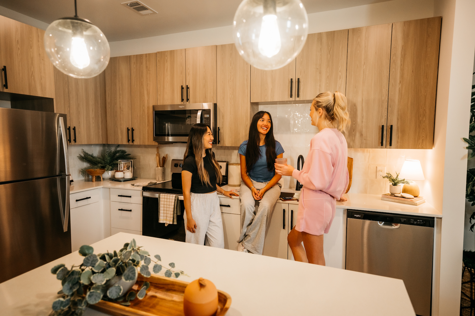 three roommates talking in their kitchen at Rambler Athens