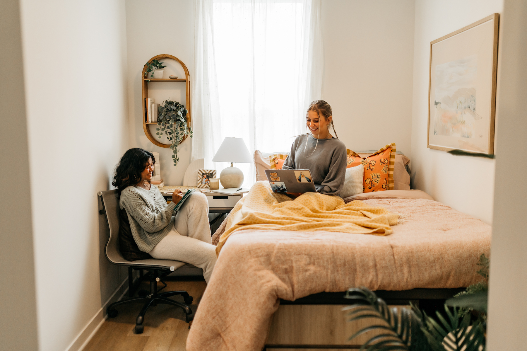 two girls roommates sitting and talking in the bedroom at Rambler Athens