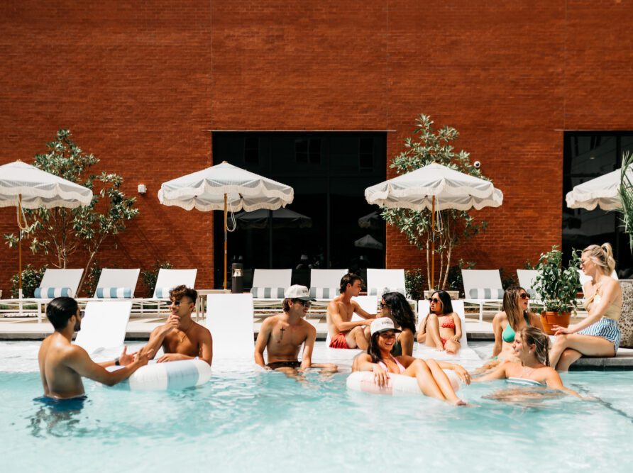 Friends hanging out at the pool at Rambler Athens